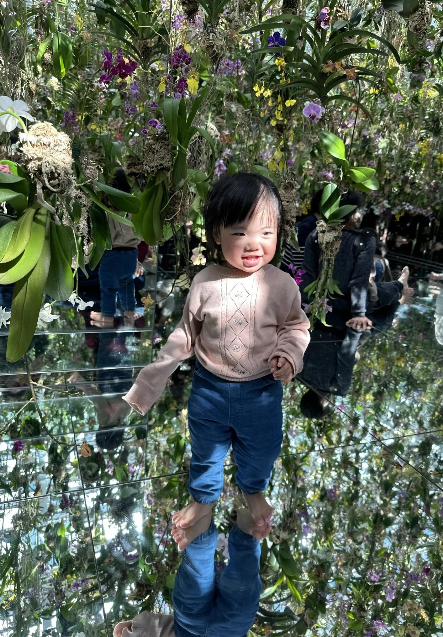 kid in teamlab japan flower forest