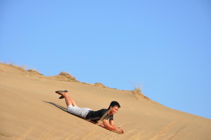 Sliding down the sand dunes at La Paz