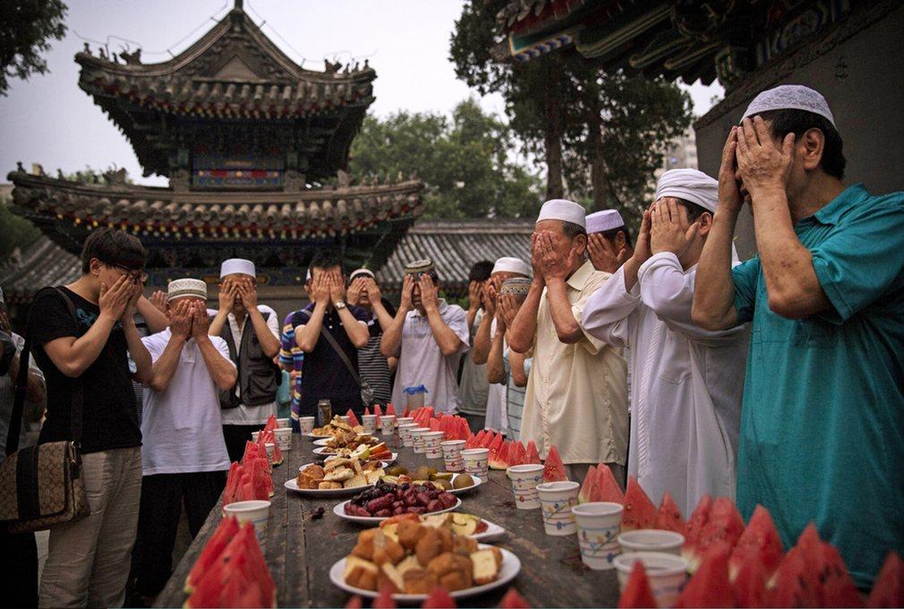 Chinese Muslims of the Hui ethnic minority pray over food before breaking their fast.