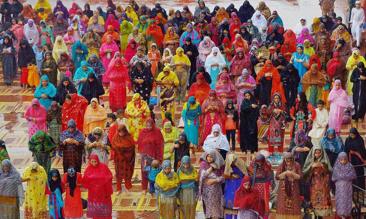 Pakistani women performing Eid prayers with their traditional clothes, salwar kameez