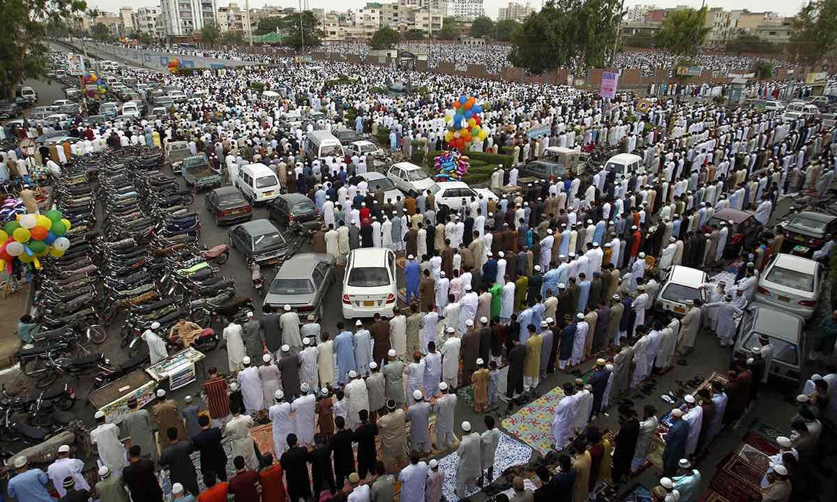 Men performing their prayers in Karachi