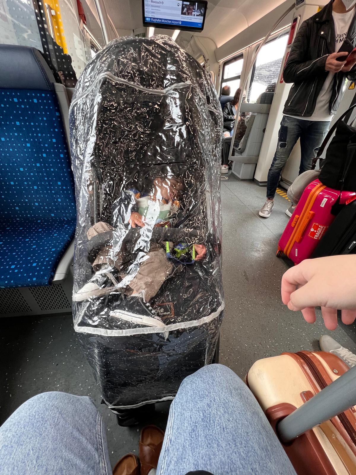 Toddler sleeping in a stroller in the train in Germany